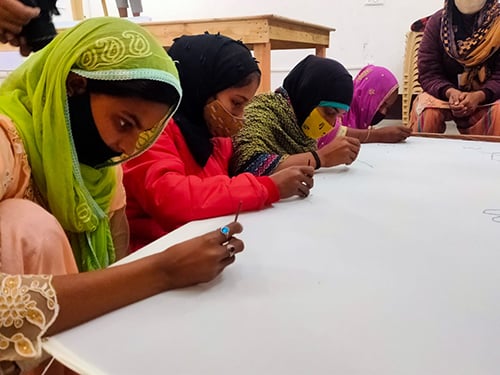 A community member practising embroidery skills in a Shikshadwar livelihood session