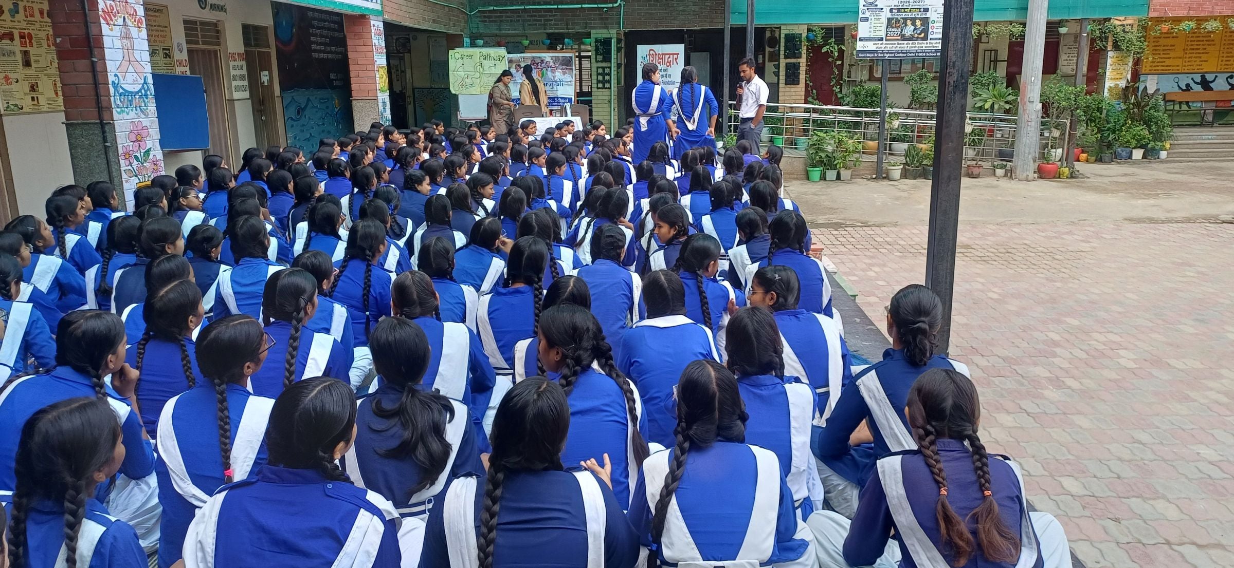 Rows of students seated for a Shikshadwar Career Pathway mentorship session at a government girls' school