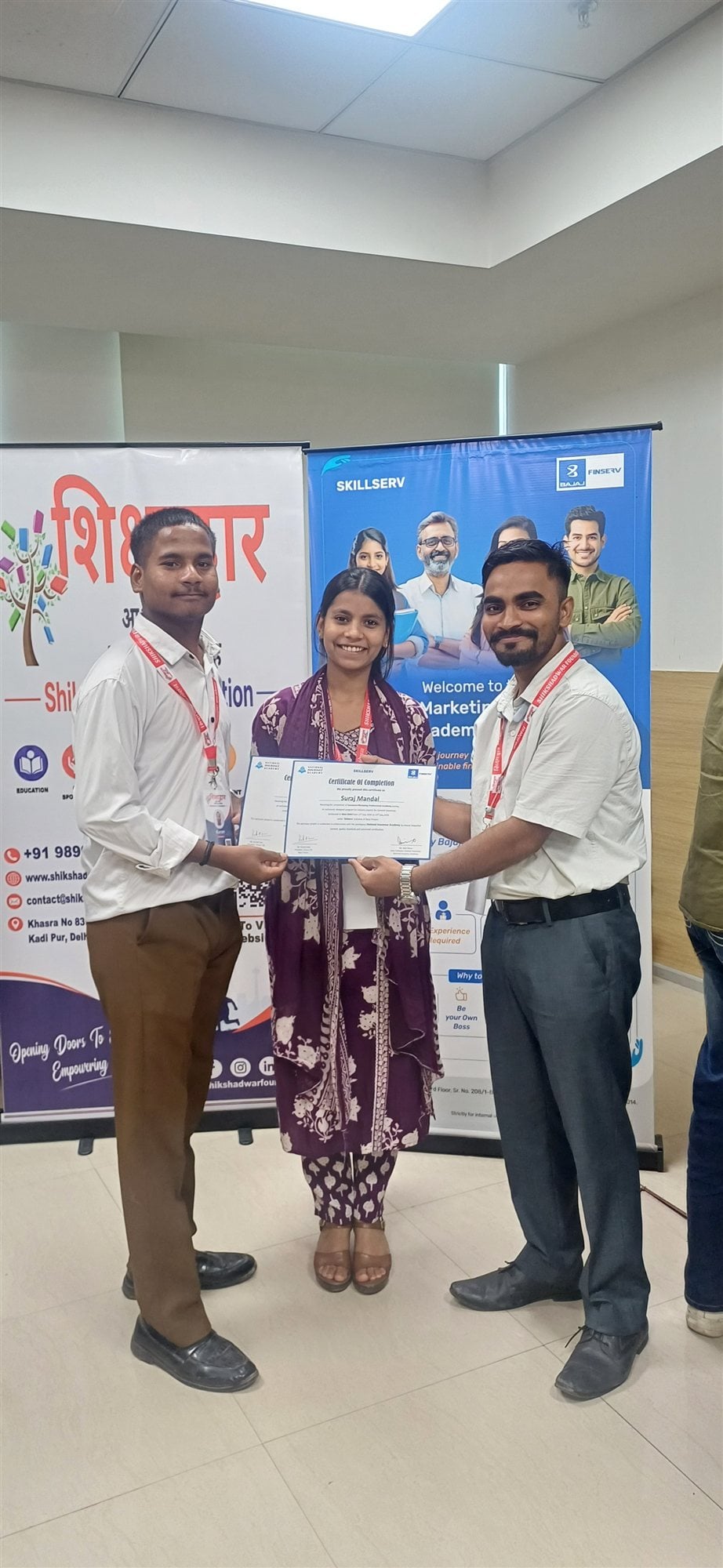 A Shikshadwar trainee receives his SkillServ insurance-marketing certificate of completion