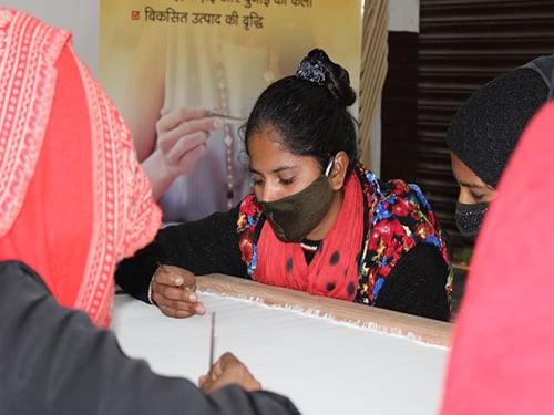 A community member practising embroidery skills in a Shikshadwar livelihood session